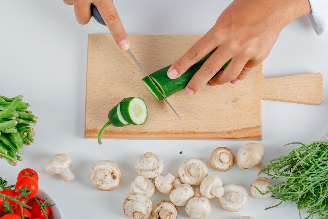 chef-cutting-cucumber-wooden-board-kitchen-uniform-front-view_176474-8941.jpg__PID:6045461e-0e75-48d7-b970-d7e55e9330c1